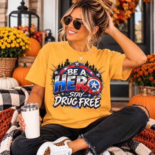 Teacher wearing Be a Hero Stay Drug Free superhero shield teacher shirt in gold