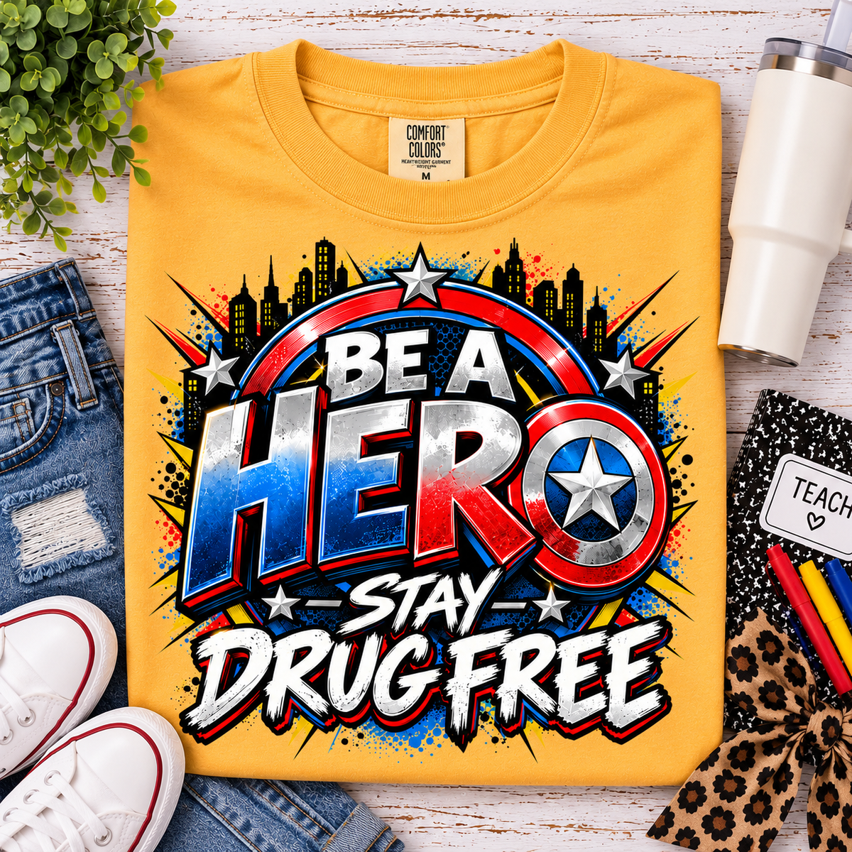 Red Ribbon Week teacher shirt - superhero shield Be a Hero Stay Drug Free design on gold Comfort Colors tee - front view