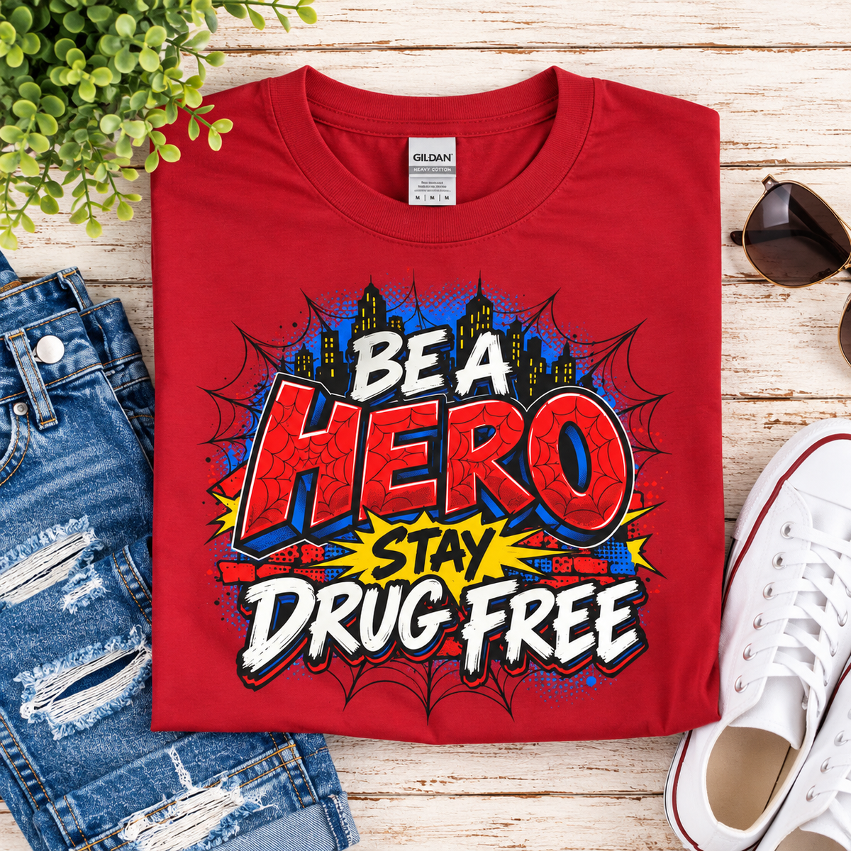 Red Ribbon Week teacher shirt - spider web Be a Hero Stay Drug Free superhero design on red Gildan Softstyle tee - flat lay close-up