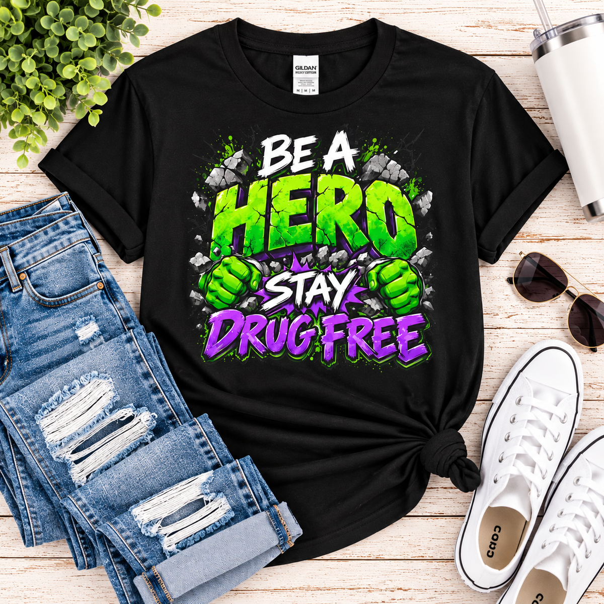 Red Ribbon Week teacher shirt - green smash Be a Hero Stay Drug Free superhero design on black Gildan Softstyle tee - flat lay outfit photo
