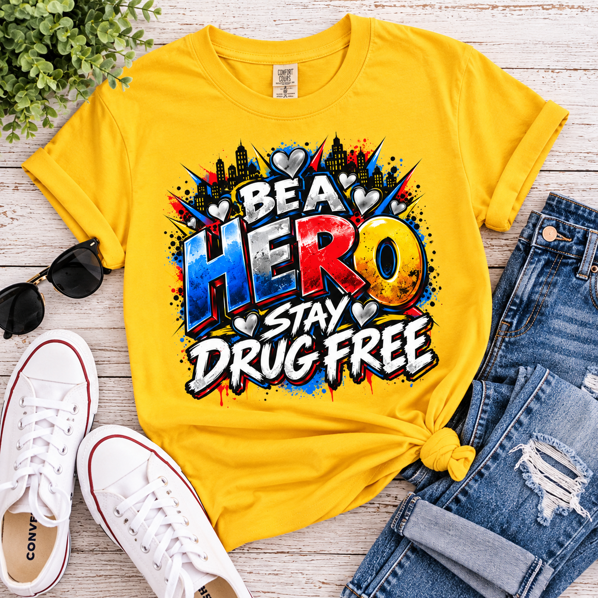 Red Ribbon Week teacher shirt - hero heart Be a Hero Stay Drug Free design on daisy yellow Gildan Softstyle tee - flat lay outfit photo