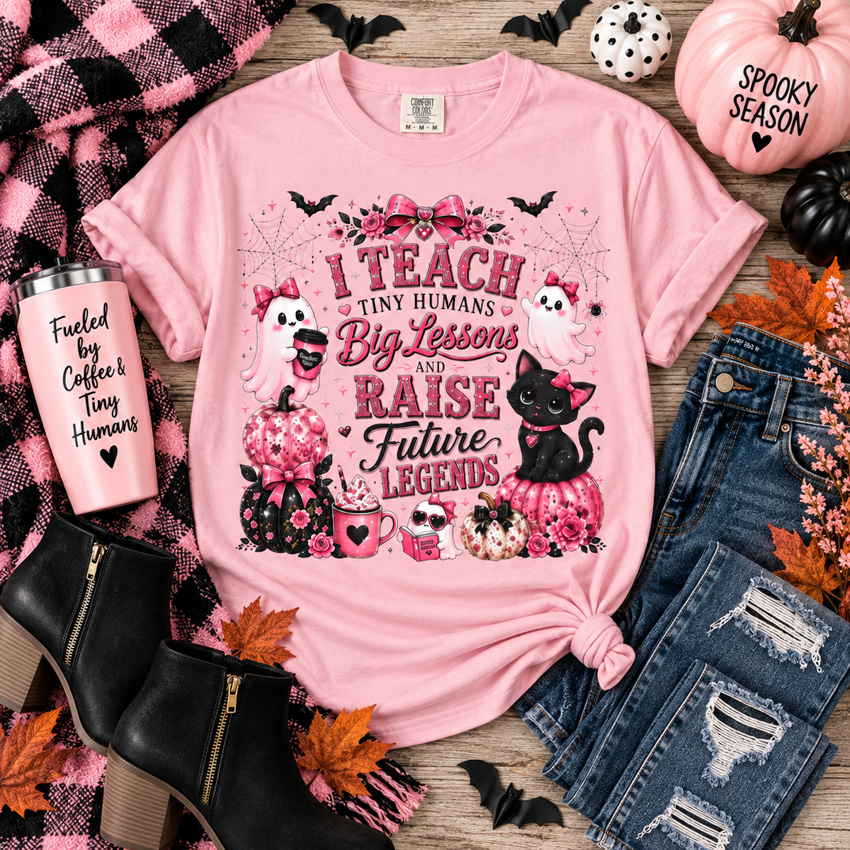 I Teach Tiny Humans Halloween shirt flat lay with cute pink ghost and black cat design.